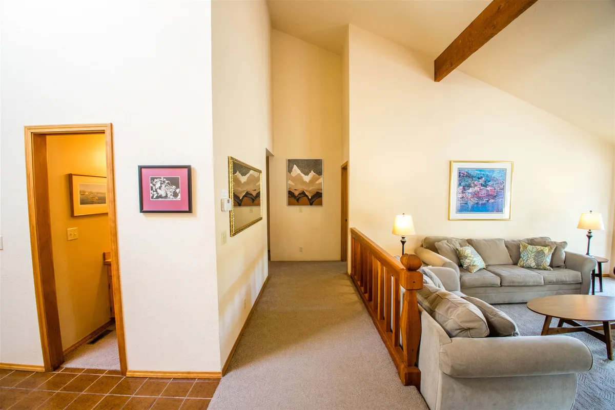 A cozy seating area featuring a comfortable sofa, warm lighting, and artistic touches creates the perfect environment for relaxing and meaningful conversation. The scene is intimate and welcoming, ideal for unwinding together after a day of adventure.